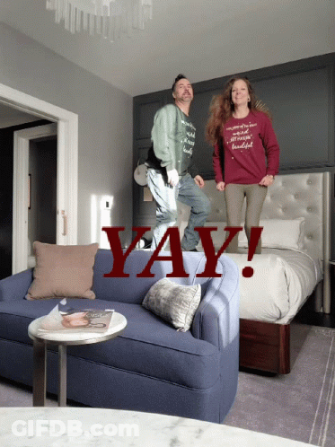 A Man And A Woman Are Jumping On A Couch With The Word Yay Written In Red GIF
