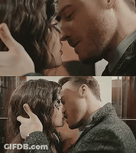 A Man And A Woman Are Kissing And Hugging GIF