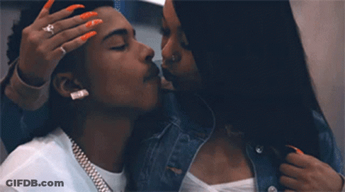 A Man And A Woman Are Kissing And The Woman Is Wearing A Ring On Her Finger GIF