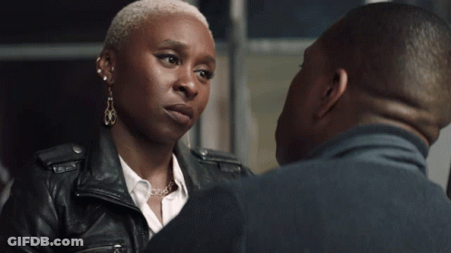 A Man And A Woman Are Kissing And The Woman Is Wearing Earrings GIF