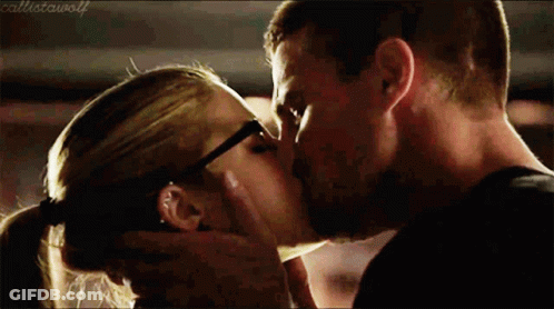 A Man And A Woman Are Kissing And The Woman Is Wearing Glasses GIF