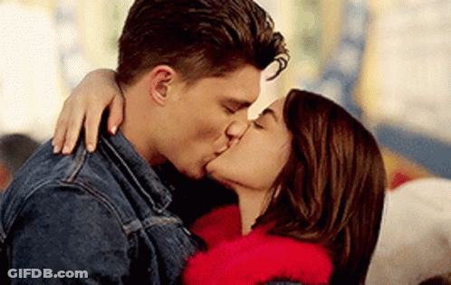 A Man And A Woman Are Kissing Each Other . GIF