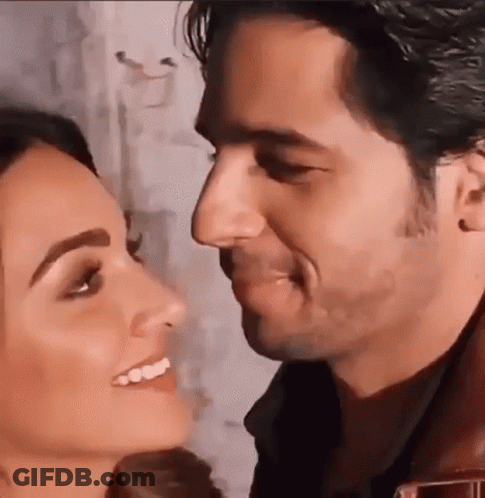 A Man And A Woman Are Kissing Each Other . GIF