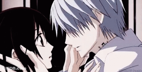 A Man And A Woman Are Kissing Each Other In A Dark Room . GIF