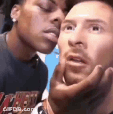A Man And A Woman Are Kissing Each Other On The Cheeks . GIF