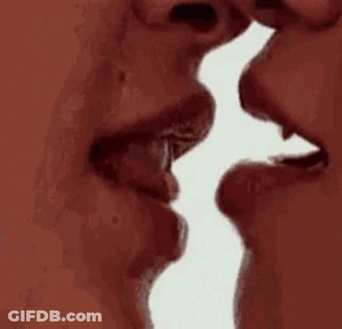 A Man And A Woman Are Kissing Each Other With Their Mouths Open . GIF