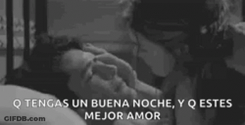 A Man And A Woman Are Kissing In A Bed . GIF