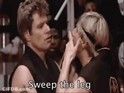 A Man And A Woman Are Kissing In A Boxing Ring And The Man Is Saying `` Sweep The Leg '' . GIF