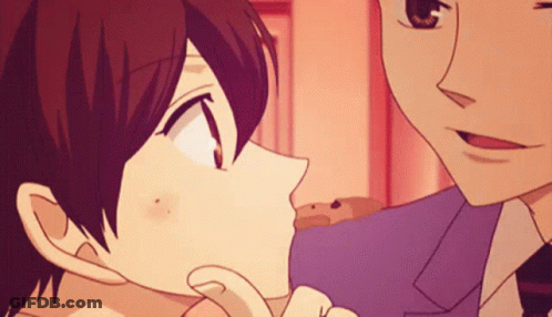 A Man And A Woman Are Kissing In A Cartoon GIF