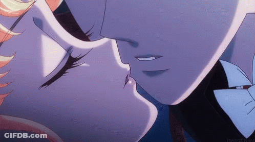 A Man And A Woman Are Kissing In A Close Up Of Their Faces GIF