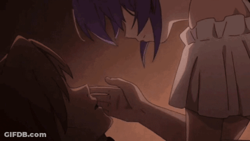 A Man And A Woman Are Kissing In A Dark Room GIF