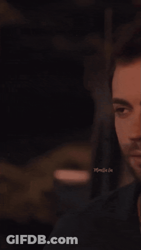 A Man And A Woman Are Kissing In A Dark Room With The Words Moreelle Lia On The Bottom GIF