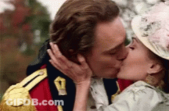 A Man And A Woman Are Kissing In A Military Uniform And Hat . GIF