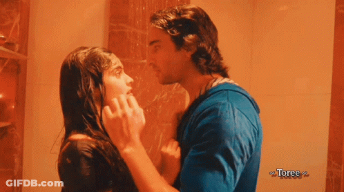 A Man And A Woman Are Kissing In A Shower With Toree Written On The Bottom Right GIF