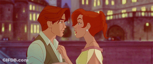A Man And A Woman Are Kissing In Front Of A Bridge GIF