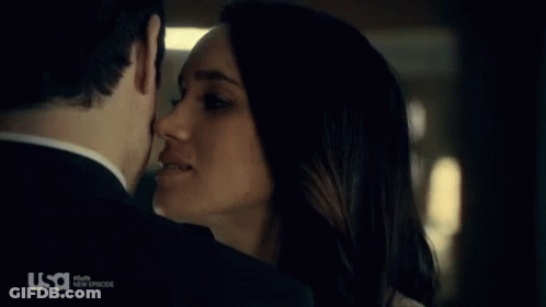 A Man And A Woman Are Kissing In Front Of A Usa Logo GIF