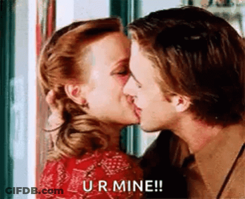 A Man And A Woman Are Kissing In Front Of A Window And The Woman Is Saying `` Ur Mine '' . GIF