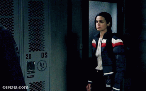 A Man And A Woman Are Kissing In Front Of Lockers With The Number 34 On Them GIF