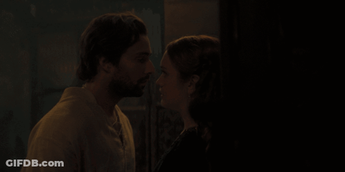 A Man And A Woman Are Kissing In The Dark GIF