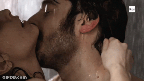 A Man And A Woman Are Kissing In The Rain With Rai Written On The Bottom GIF
