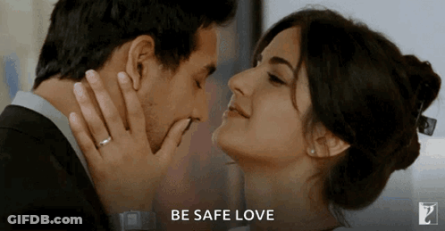 A Man And A Woman Are Kissing With The Words Be Safe Love Behind Them GIF