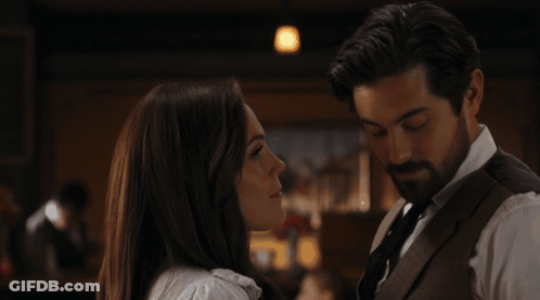 A Man And A Woman Are Kissing With The Words Oh What The Heck Below Them GIF