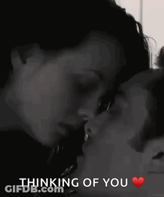 A Man And A Woman Are Kissing With The Words `` Thinking Of You '' Written Below Them . GIF