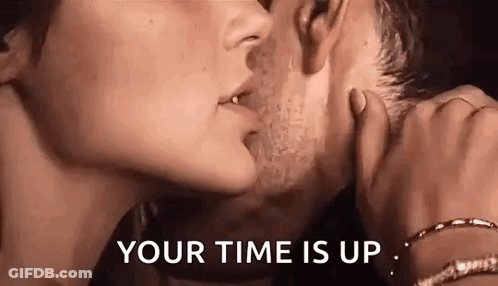 A Man And A Woman Are Kissing With The Words `` Your Time Is Up '' Behind Them . GIF