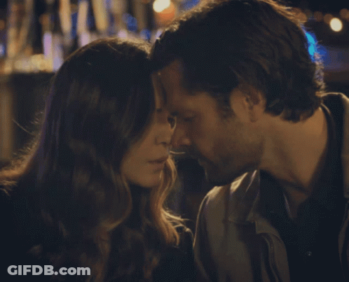 A Man And A Woman Are Kissing With Their Eyes Closed GIF