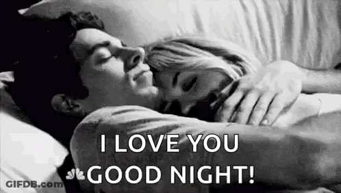 A Man And A Woman Are Laying In Bed Hugging Each Other And The Man Is Saying `` I Love You Good Night '' . GIF