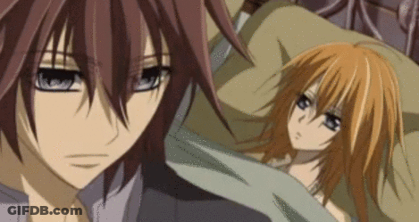 A Man And A Woman Are Laying In Bed Together . GIF