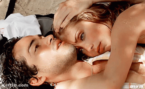A Man And A Woman Are Laying On A Beach With The Words Gifs Of Ata On The Bottom Right GIF