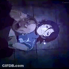 A Man And A Woman Are Laying On Top Of Each Other On The Floor . GIF
