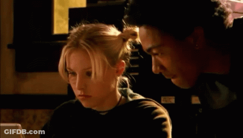 A Man And A Woman Are Looking At A Computer Screen And The Woman Is Saying " Ruh Roh " GIF