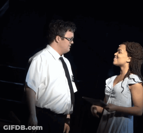 A Man And A Woman Are Looking At A Tablet GIF