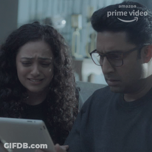A Man And A Woman Are Looking At A Tablet With An Amazon Prime Video Logo In The Background GIF
