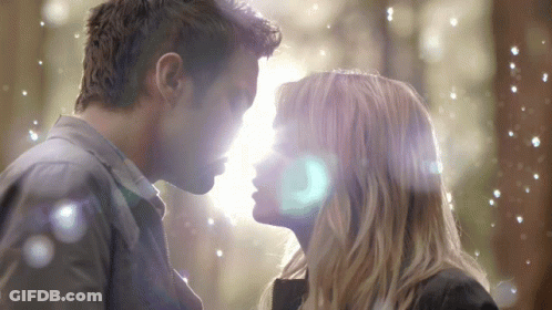 A Man And A Woman Are Looking At Each Other GIF