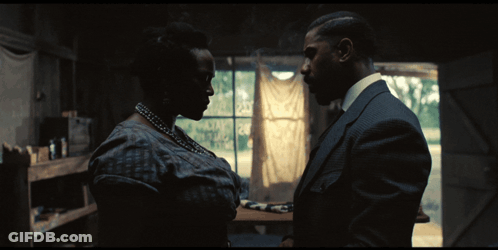A Man And A Woman Are Looking At Each Other GIF