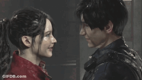 A Man And A Woman Are Looking At Each Other And Smiling GIF