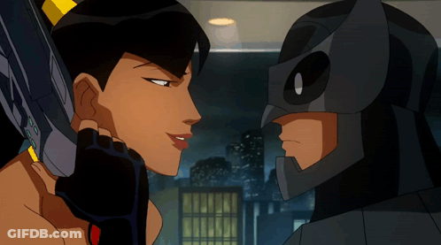 A Man And A Woman Are Looking At Each Other And The Man Is Wearing A Mask GIF
