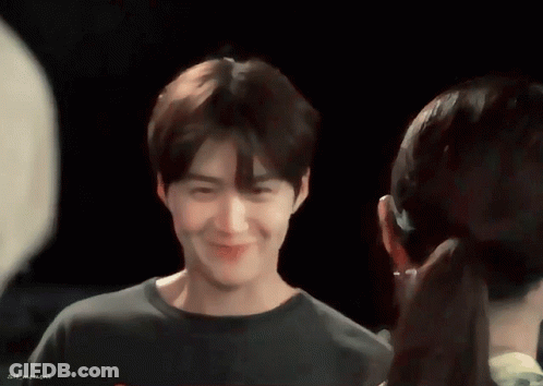 A Man And A Woman Are Looking At Each Other And The Man 'S Shirt Says Sin Moment GIF