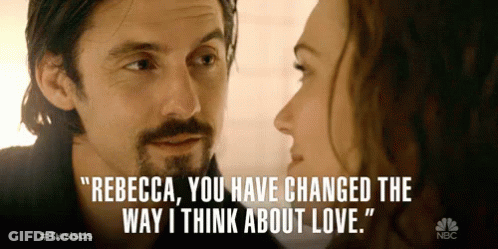 A Man And A Woman Are Looking At Each Other And The Man Says Rebecca GIF