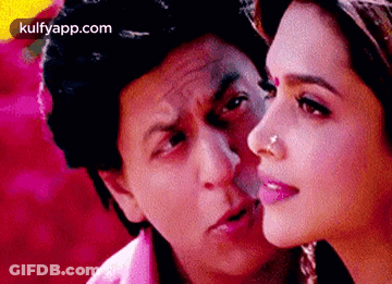 A Man And A Woman Are Looking At Each Other And The Woman Has A Nose Ring . GIF