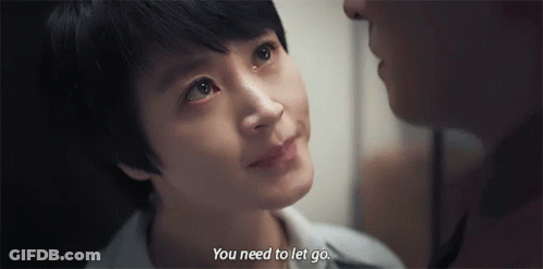 A Man And A Woman Are Looking At Each Other And The Woman Is Crying . GIF