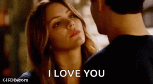 A Man And A Woman Are Looking At Each Other And The Woman Is Saying I Love You . GIF