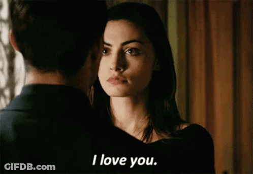 A Man And A Woman Are Looking At Each Other And The Woman Is Saying I Love You . GIF