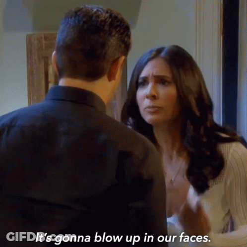 A Man And A Woman Are Looking At Each Other And The Woman Is Saying It 'S Gonna Blow Up In Our Faces GIF