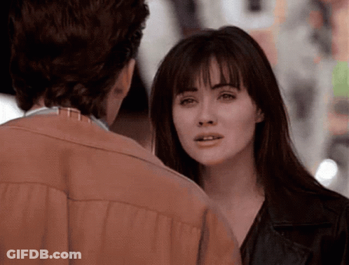A Man And A Woman Are Looking At Each Other And The Woman Is Wearing A Brown Jacket GIF