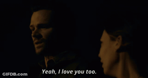 A Man And A Woman Are Looking At Each Other And The Woman Says Yeah I Love You Too GIF