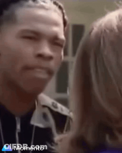 A Man And A Woman Are Looking At Each Other And The Word Momento Is On The Bottom Of The Screen GIF